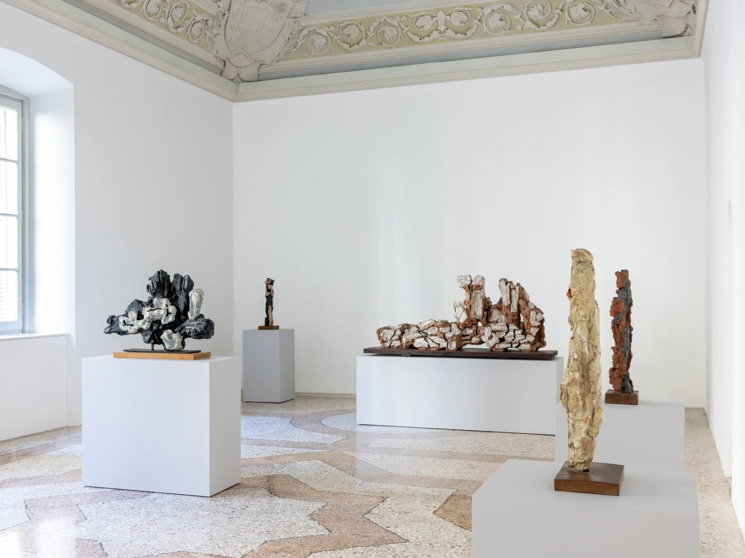 Sculptures by Leoncillo installed in a bright room at Palazzo Belgioioso.