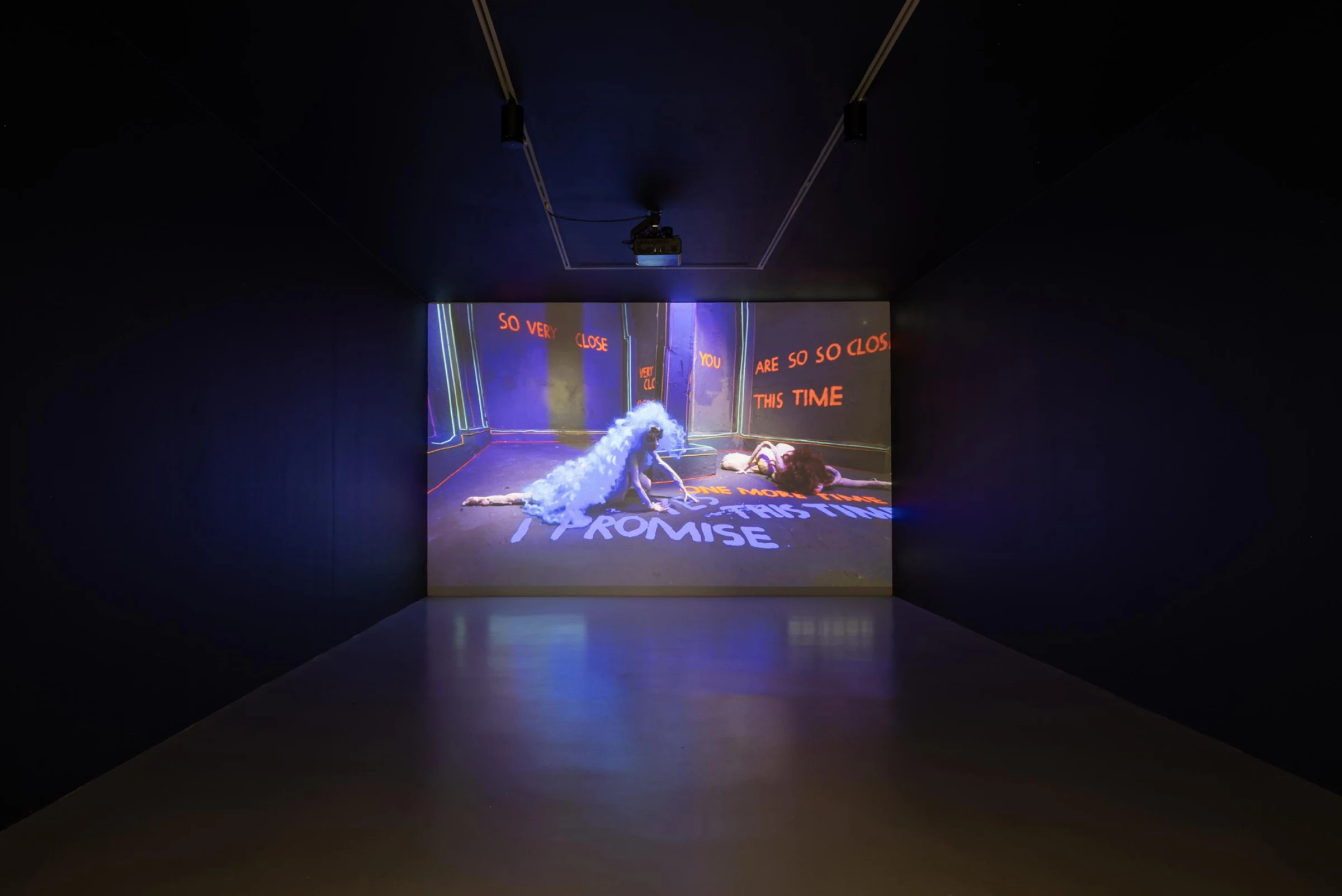 A vivid animated projection illuminates a darkened gallery in Song of the Sirens.
